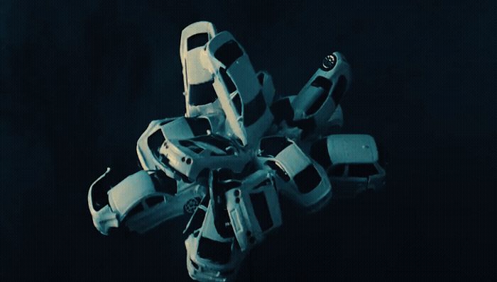 a robotic hand holding a cell phone in a dark room