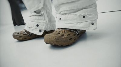 a person standing on a white floor wearing a pair of shoes