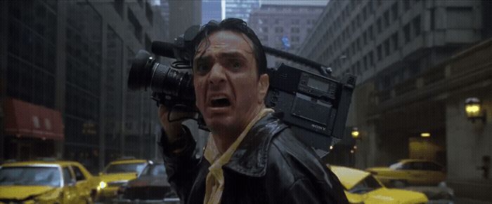 a man holding a camera up to his face