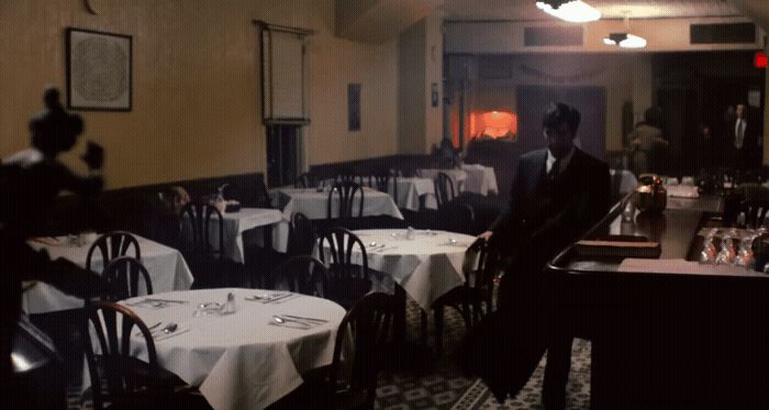 a man sitting at a table in a restaurant