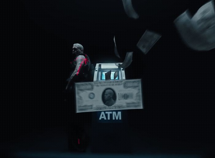 a man standing in front of a stack of money