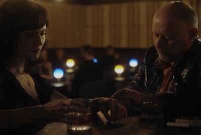 a man and a woman sitting at a bar