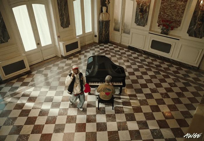 a couple of people that are standing in front of a piano