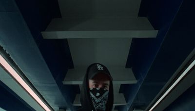 a man standing in a hallway with a hoodie on