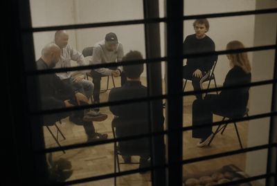 a group of people sitting in chairs in a room