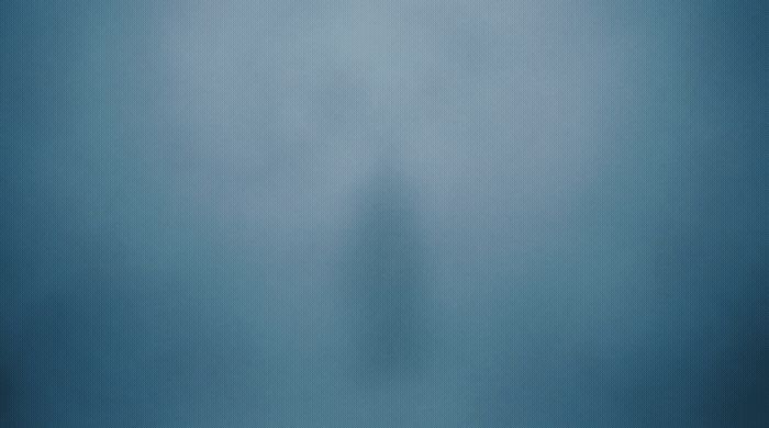 a person standing in the middle of a foggy room