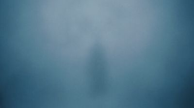 a person standing in the middle of a foggy room