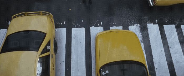 a yellow taxi cab is parked in a parking lot