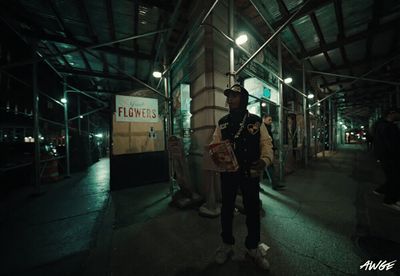 a man is standing in the middle of the street at night