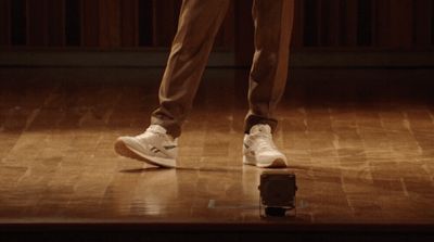 a man standing on top of a hard wood floor