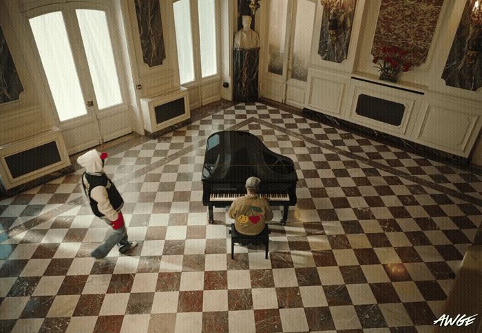 a man standing in front of a piano in a room