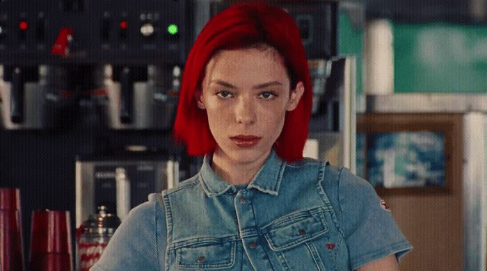 a woman with red hair in a denim shirt