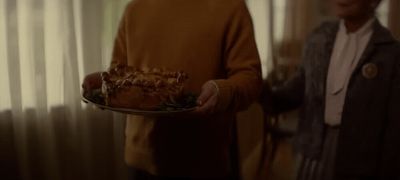 a man holding a plate with a cake on it