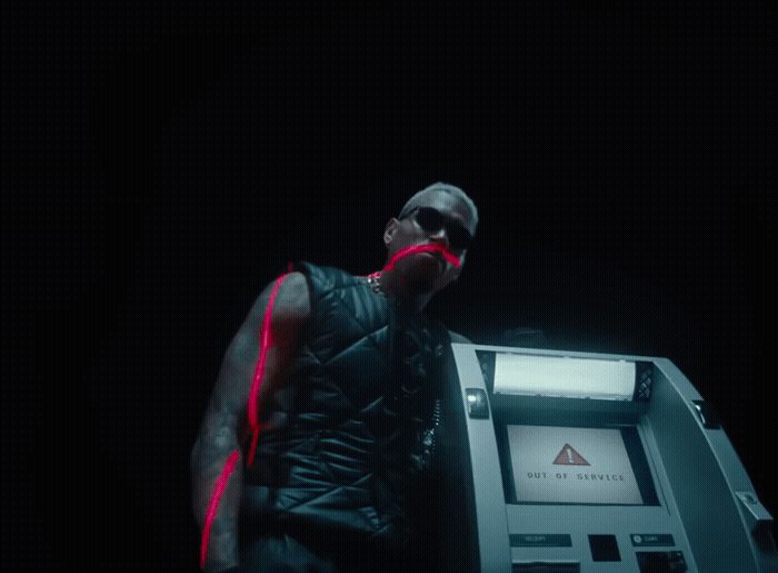 a man standing next to a machine in the dark