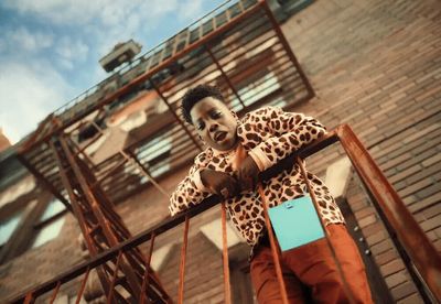 a man standing on top of a metal hand rail
