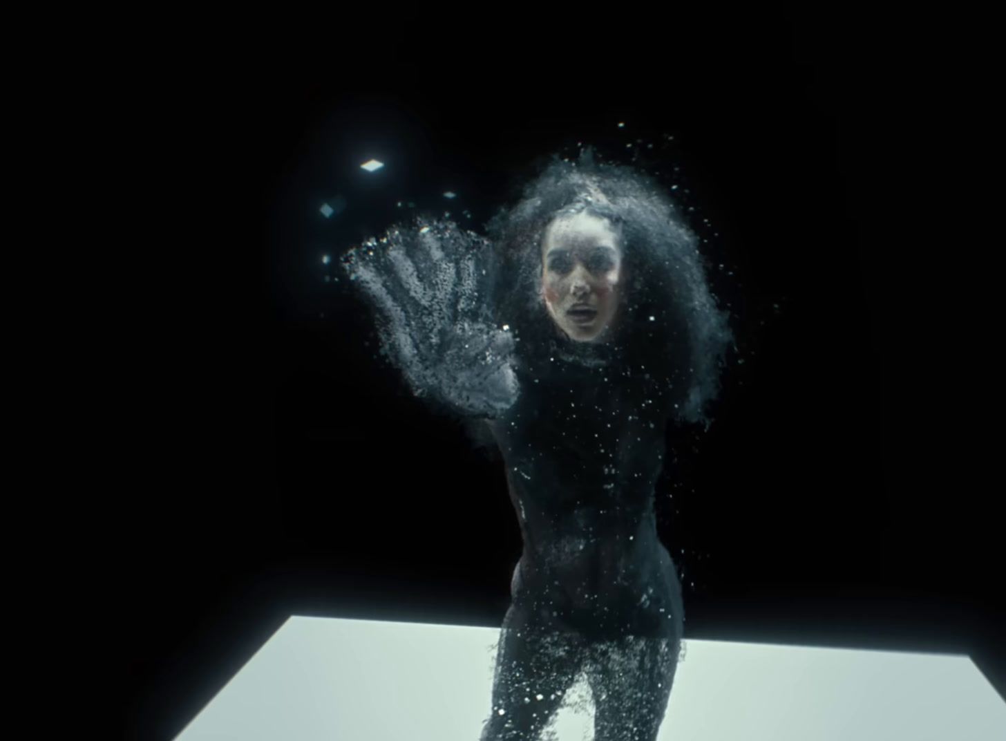 a woman standing on top of a white table under water