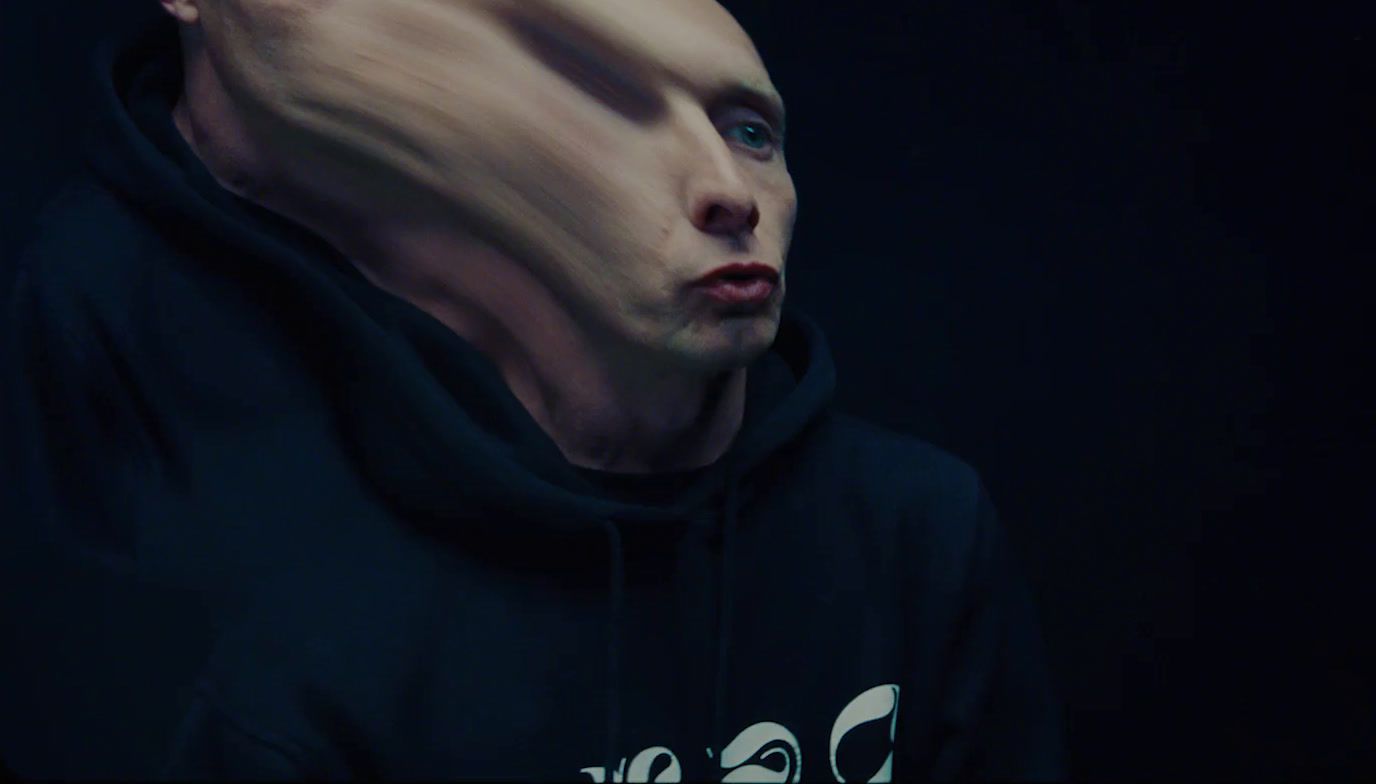 a man in a black hoodie with a strange look on his face