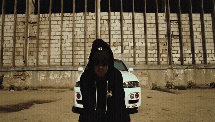 a man standing in front of a white car