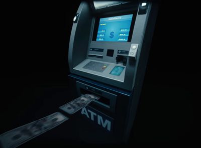 a atm machine with a lot of money coming out of it