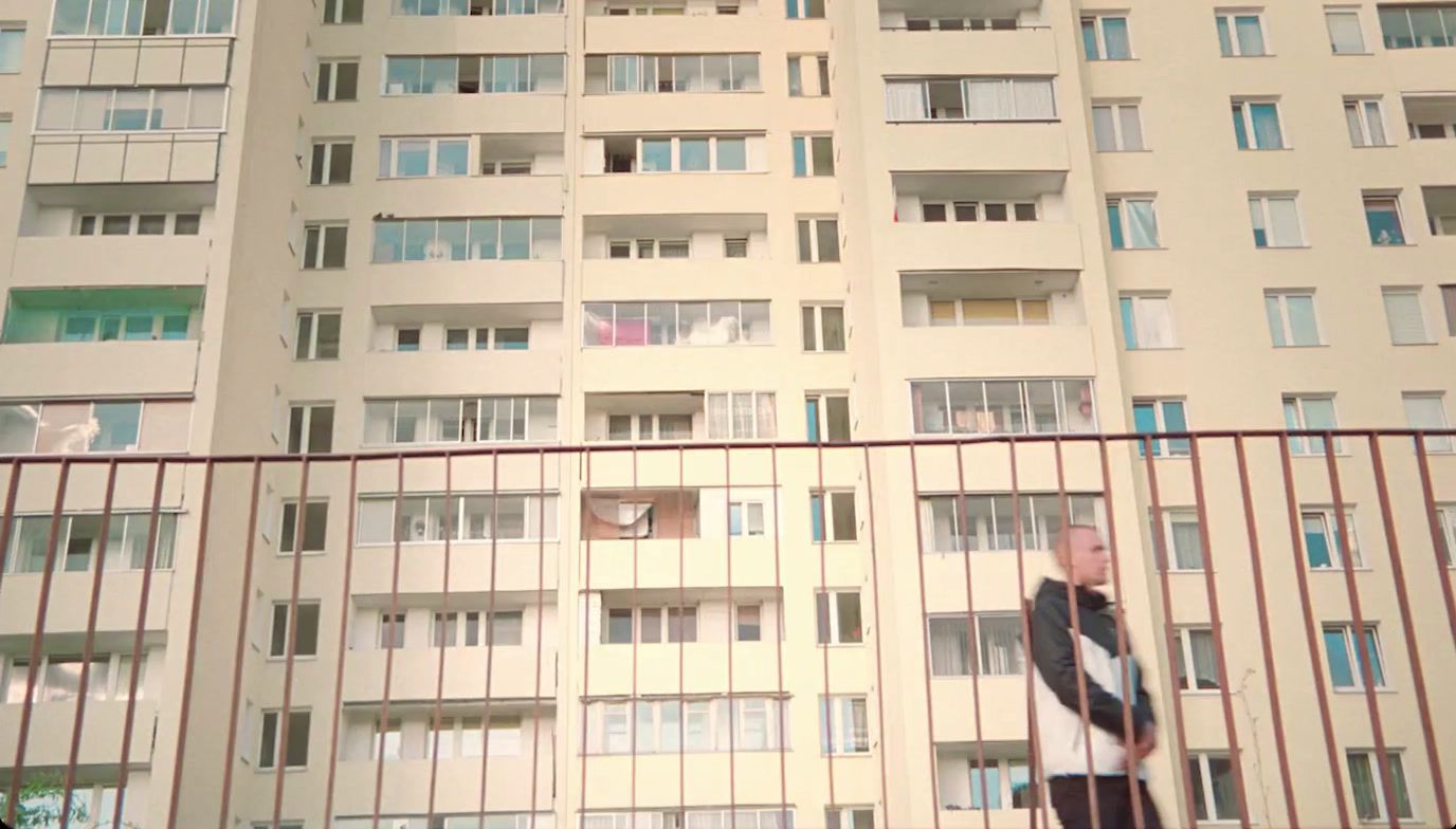 a man standing in front of a tall building