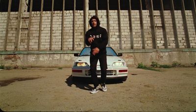 a man sitting on the hood of a car