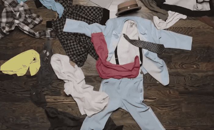 a pile of clothes sitting on top of a wooden floor