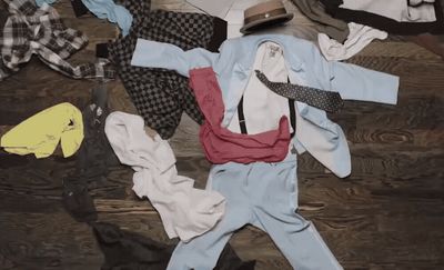 a pile of clothes sitting on top of a wooden floor