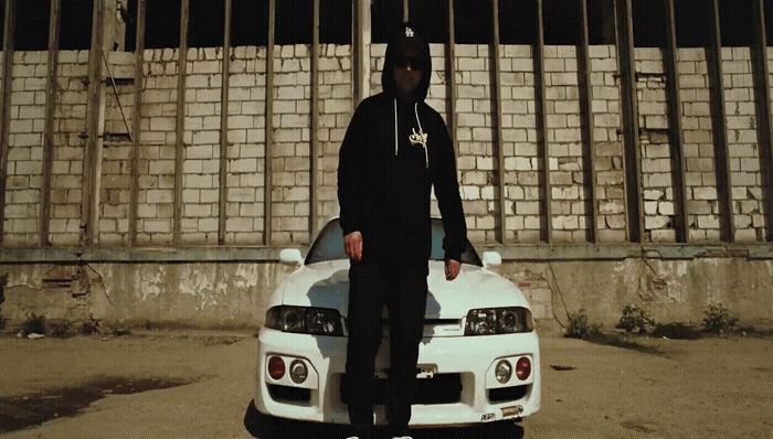 a man standing on top of a white car