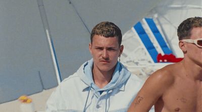 a couple of men sitting next to each other on a boat