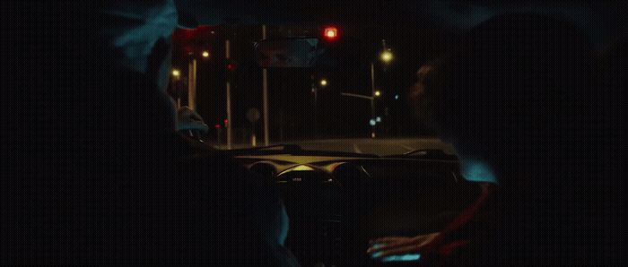 a person sitting in a car at night