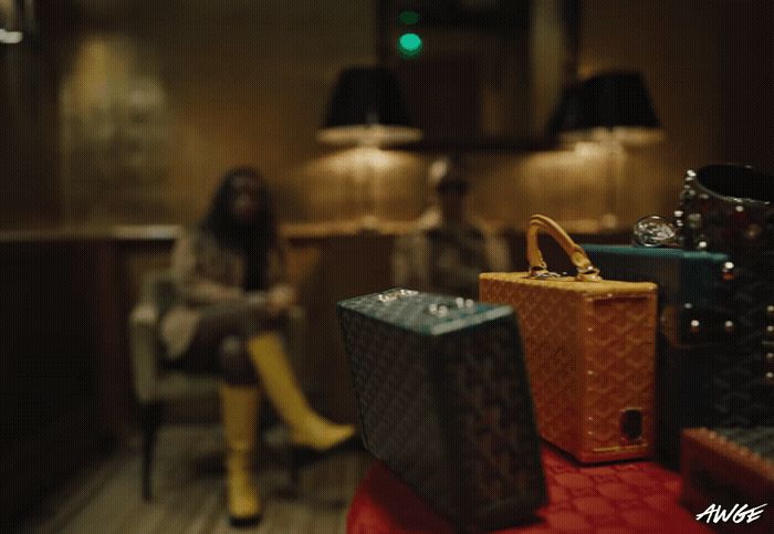 a woman sitting in a chair next to a pile of luggage