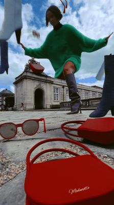 a woman in a green sweater and some sunglasses