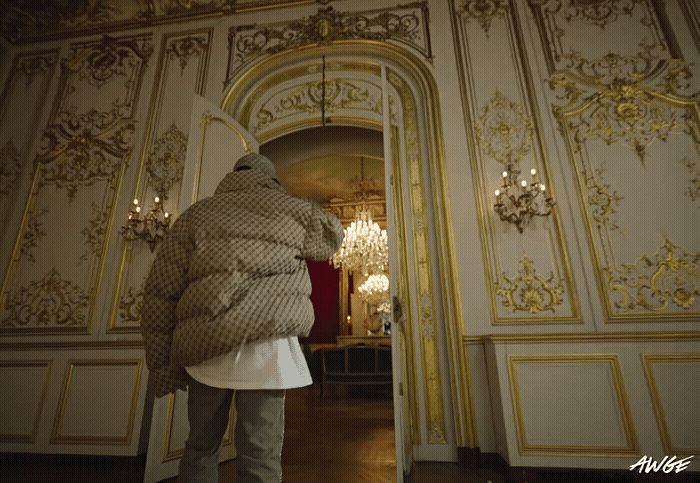 a person standing in a room with a coat on