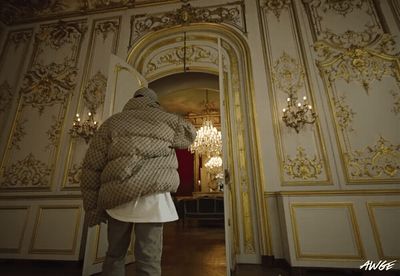 a person standing in a room with a coat on