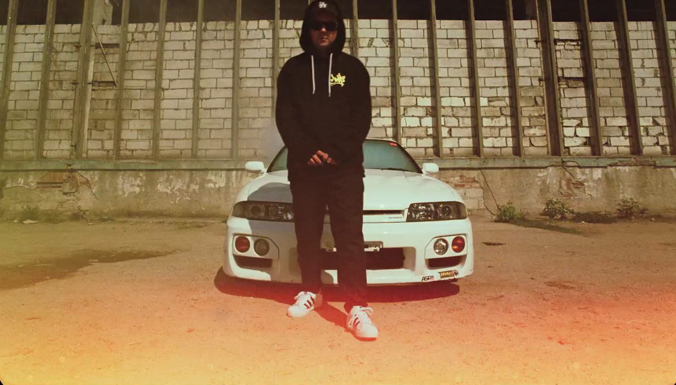 a man standing in front of a white car