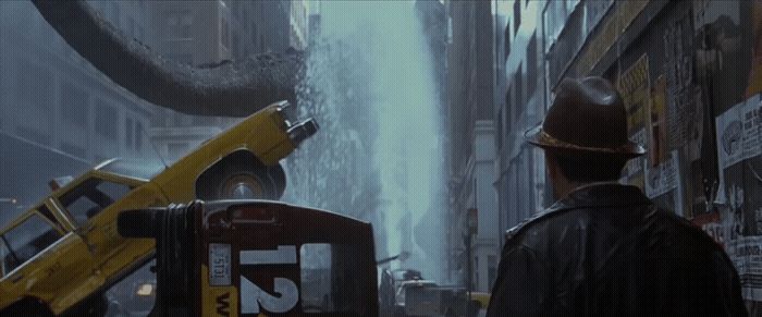 a man standing next to a bulldozer on a city street