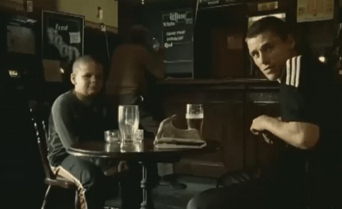 two men sitting at a table in a restaurant