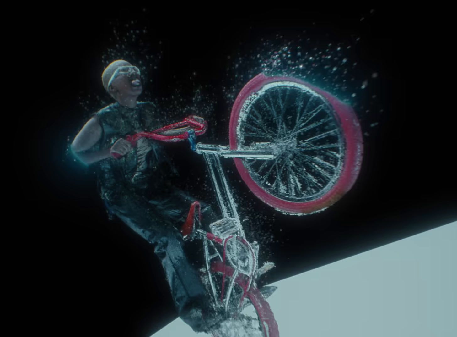 a man riding a bike on top of a snow covered slope