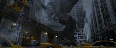 a giant godzilla is in the middle of a city street