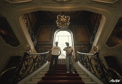 a couple of men standing on top of a set of stairs