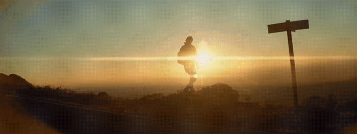 a person standing on top of a mountain at sunset