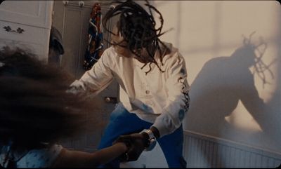 a woman with dreadlocks standing in a room