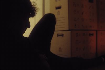 a person sitting in front of a filing cabinet