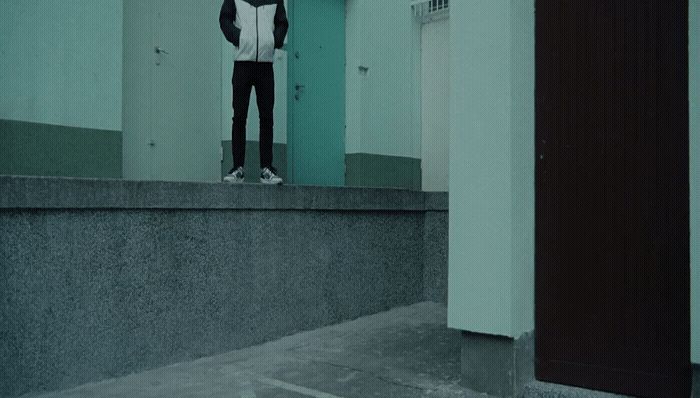 a person standing on a ledge in a hallway