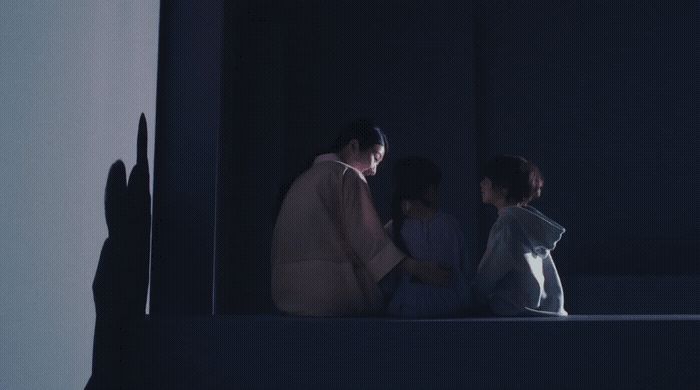 a group of people sitting on top of a window sill