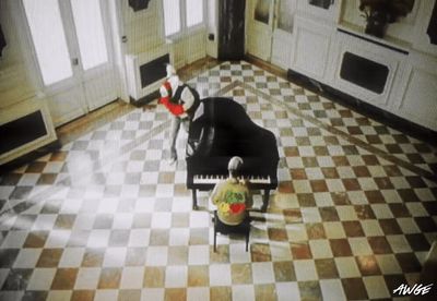 a living room with a piano in the middle of the floor