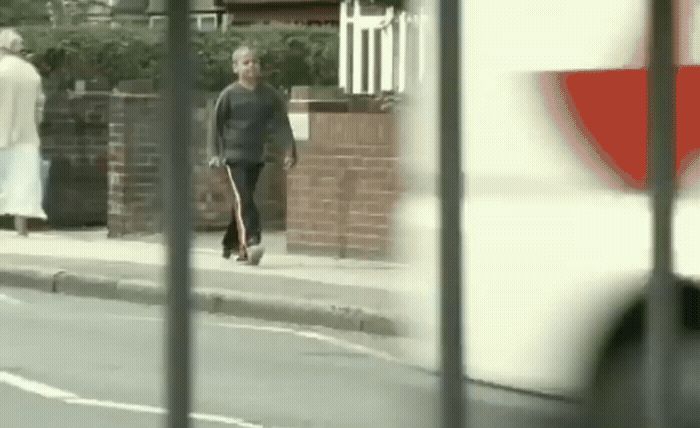 a man walking down the street with a skateboard