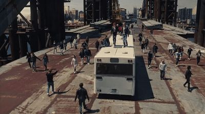 a group of people walking across a bridge