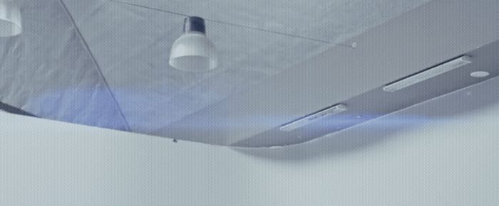 a ceiling mounted light fixture in a white room