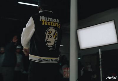 a man wearing a vest that says human testing
